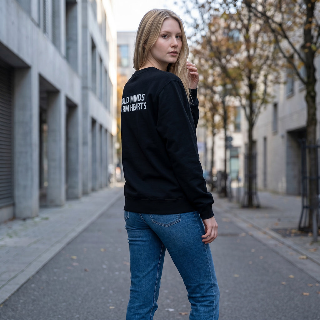 Icy Culture black crewneck sweatshirt with "COLD MINDS, WARM HEARTS" print on back. Unisex fit, 50% cotton/50% polyester.