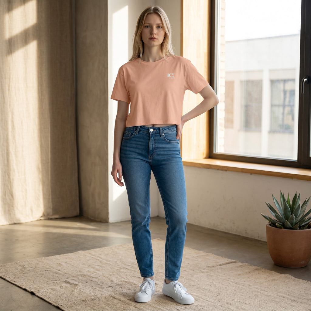 Icy Culture crop tee in peach cotton with a small white logo on the chest. Relaxed fit, short length.