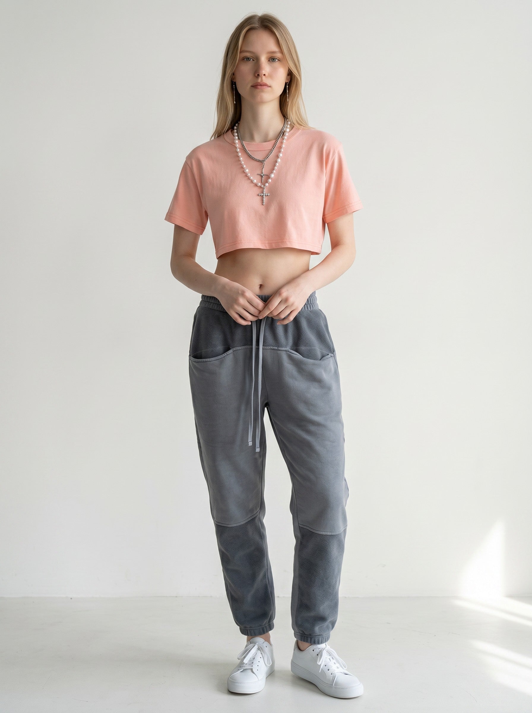 Icy Culture pink cotton crop top with short sleeves and round neck, paired with grey sweatpants.