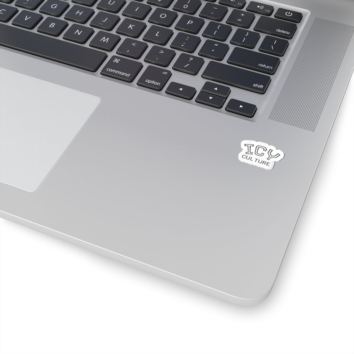 Icy Culture sticker with white outline on a silver laptop keyboard.