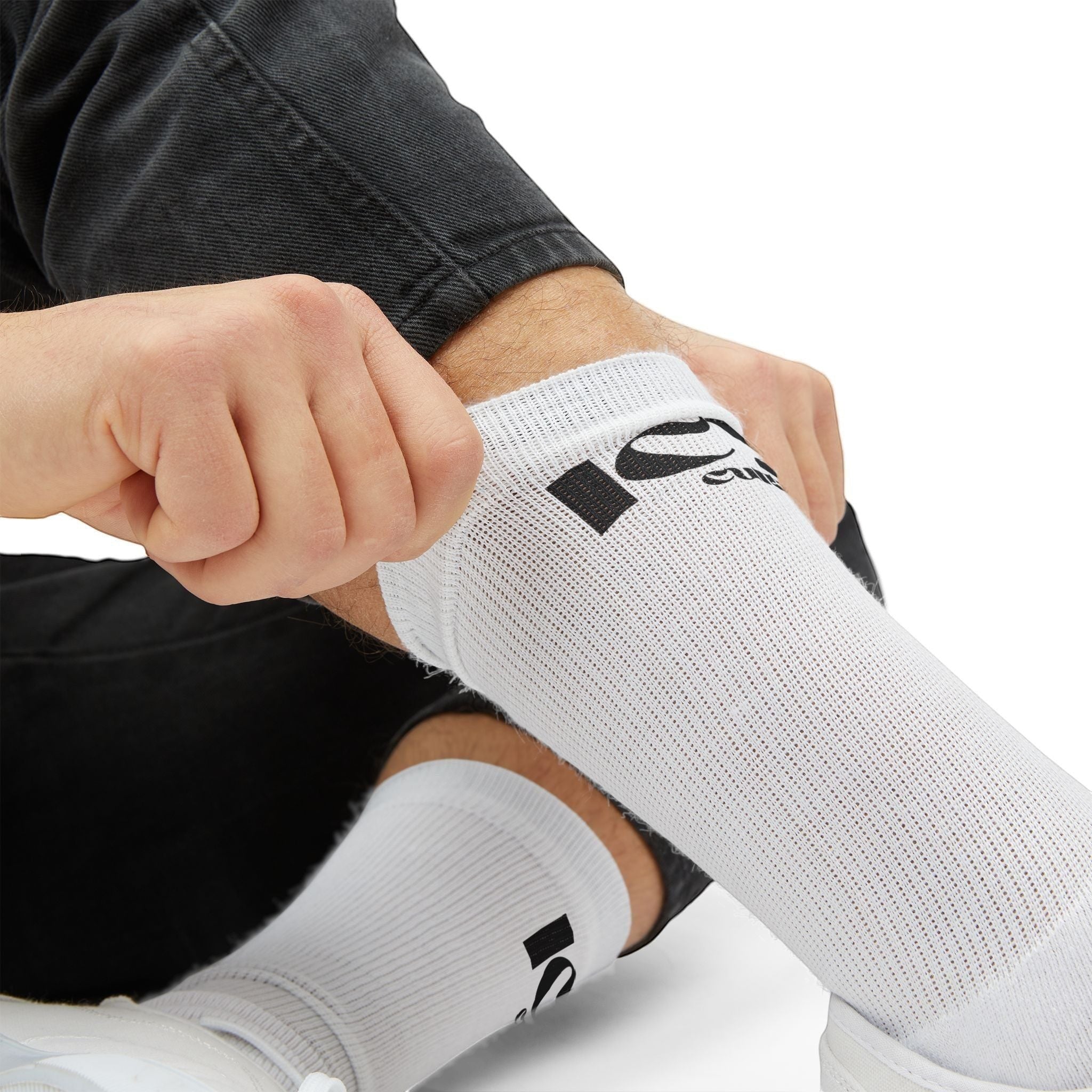 Icy Culture white crew socks with black logo detail, made from a polyester-spandex blend for comfort.